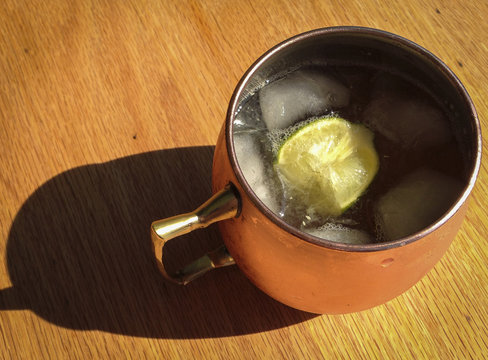 cold drink with lime in copper cup