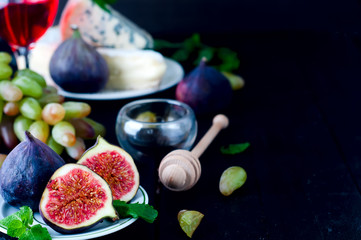 Grape and figs with on wooden table background.