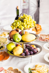Plate full of fresh fruits on a festive table
