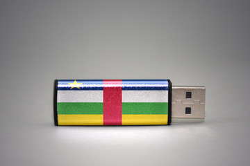 usb flash drive with the national flag of central african republic on gray background.