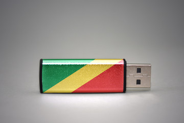 usb flash drive with the national flag of republic of the congo on gray background.