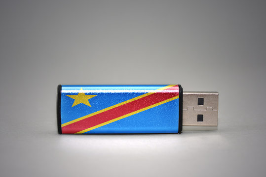 usb flash drive with the national flag of democratic republic of the congo on gray background.