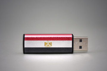 usb flash drive with the national flag of egypt on gray background.