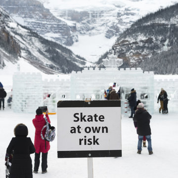 Warning Signboard With People At Ski Resort, Lake Louise, Banff