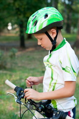 boy wearing a helmet on a bicycle
