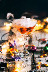 Halloween: Lights Glow Around Orange Potion In Martini Glass