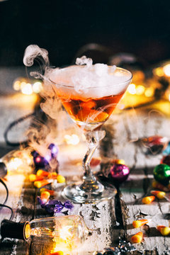 Halloween: Lights Glow Around Orange Potion In Martini Glass