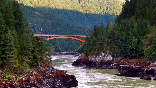 4K Arch Bridge over Fraser River, Green Water and Dark Forest, Landscape