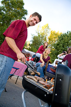 Tailgating: Man Working The Grill At Tailgate Party