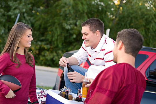 Tailgating: Friends Having Drinks And Talking About Game