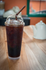 Iced Americano black coffee on a wooden table