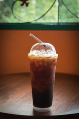 Iced Americano black coffee on a wooden table