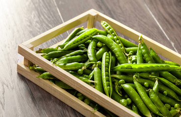 Peas group in wooden box on dark wooden table