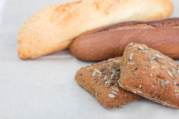 Brown and white breads with seeds on table
