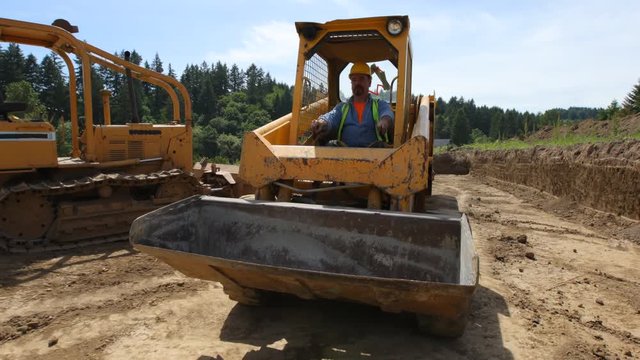 Construction worker driving excavation equipment