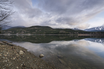View of calm lake with mountains, Whistler, British Columbia, Ca
