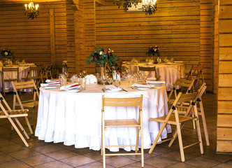 Elegant beautiful decorated table with utensils, vases of flower