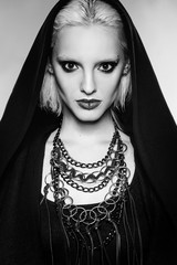 beautiful fashion gothic girl with blond hair, black make up and piercing