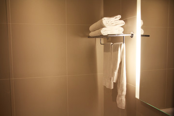 Hotel bathroom with clean white towels and copy space to be used as a background