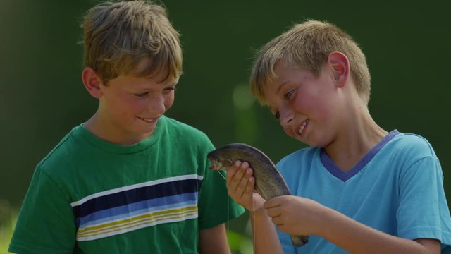 Boys playing with fish