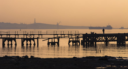 Fototapeta na wymiar Pier and fisher