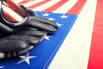 Ski goggles and gloves over USA flag - close up shot