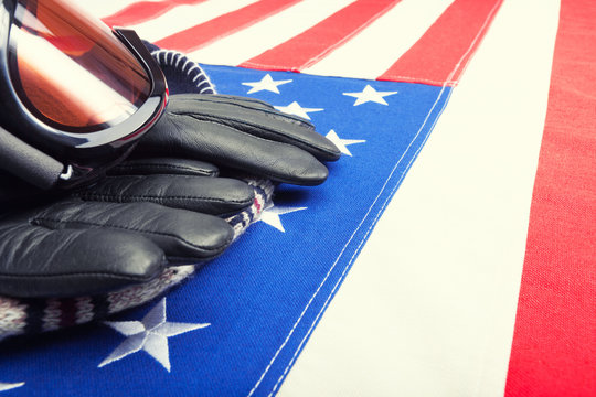 Ski Goggles And Gloves Over USA Flag - Close Up Shot