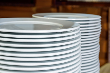 stack of white plates on the table