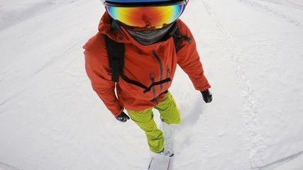 Snowboarder going of a ski slope to freeride in powder, making dynamic turns, face view, best part starts at 0:18
