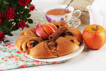 bun roll with apple and cinnamon raisin in a still life on plate bright