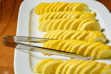 Sliced lemon on the white plate