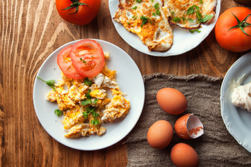 Scrambled, fried, boiled eggs on a wooden table