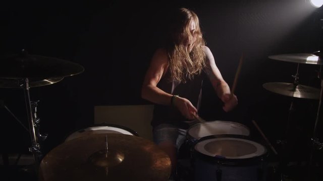 Drummer in heavy metal rock band, slow motion