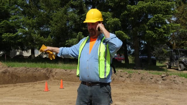 Blue collar worker walking and talking on phone