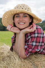 Portrait of young pretty woman with hat in straw