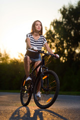 girl on a bicycle at sunset