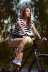 Fototapeta premium girl on a bicycle at sunset