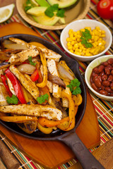 Chicken Fajitas with Grilled Onions and Bell Peppers serve with Tortillas. Selective focus.