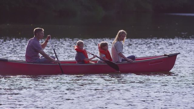 Family paddling canoe