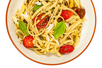 Pasta With Pesto and Roasted Tomatoes Isolated on White. Selective focus.