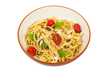 Pasta With Pesto and Roasted Tomatoes Isolated on White. Selective focus.