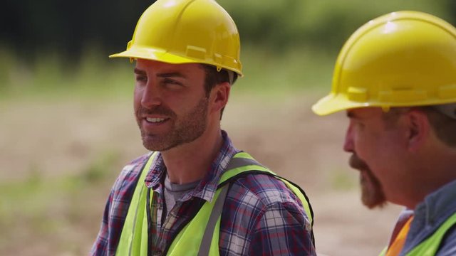 Two blue collar workers having lunch on job site
