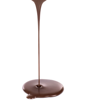Hot melted chocolate pouring on white background