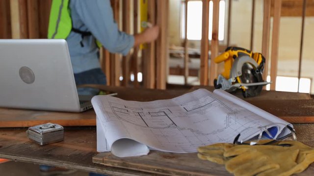 House plans and tools on construction site