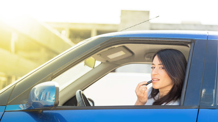 Happy woman driving her car