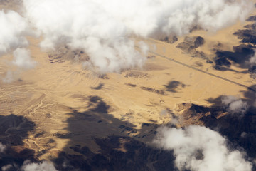 Fototapeta premium Aerial view of clouds over the land, the landscape. The texture of the scenic sky and desert Sands in the United States. 