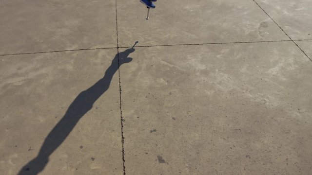 Boy jumping on Pogo stick, shadow