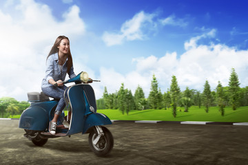 Plakat Asian woman riding scooter