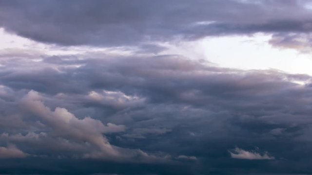 Ultra high definition 4k closeup time lapse video of moving stormy clouds and sky from daylight into sunset 4096x2304