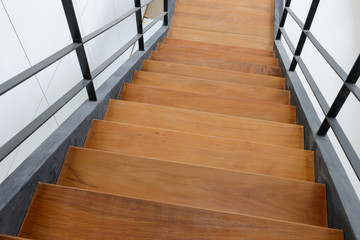 wooden staircase with iron banister